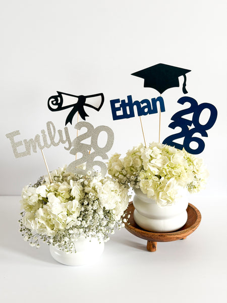 Custom graduation centerpiece set in silver glitter with cursive name and diploma and navy with print name and back cap